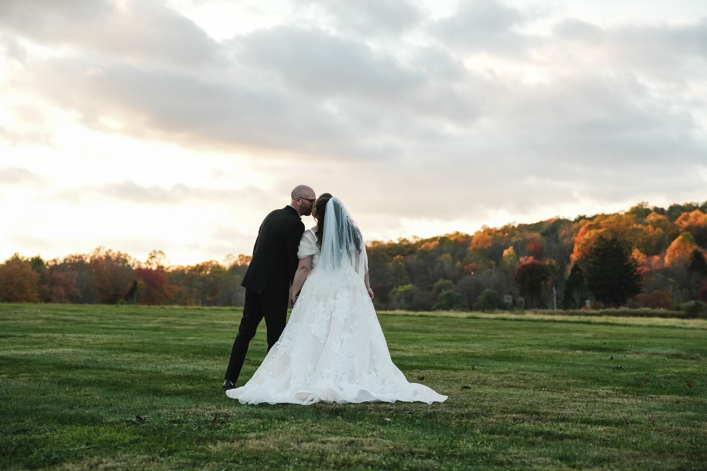 Newlyweds embracing in the meadow at Bally Spring Inn