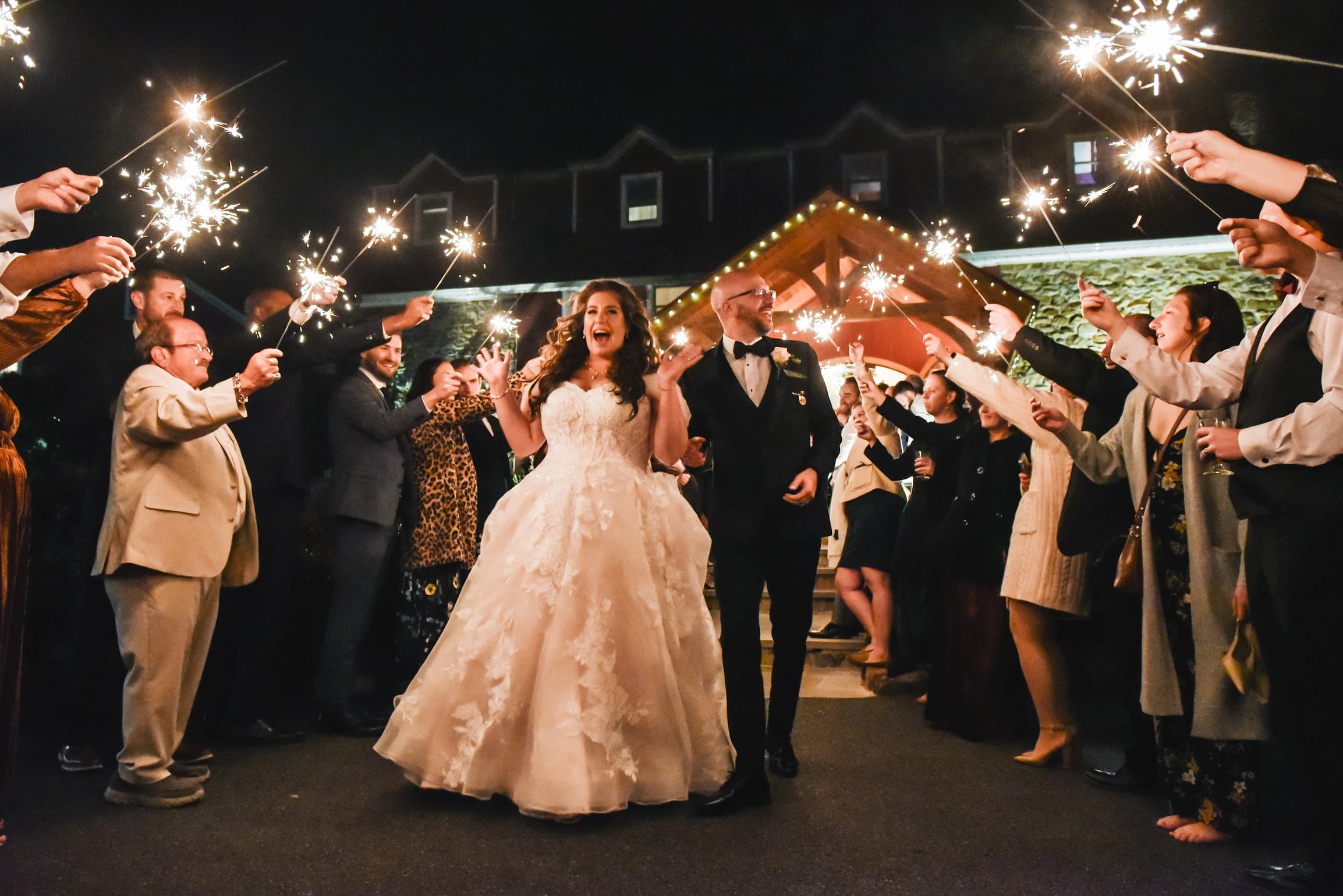 Newlyweds celebrating during a sparkler exit